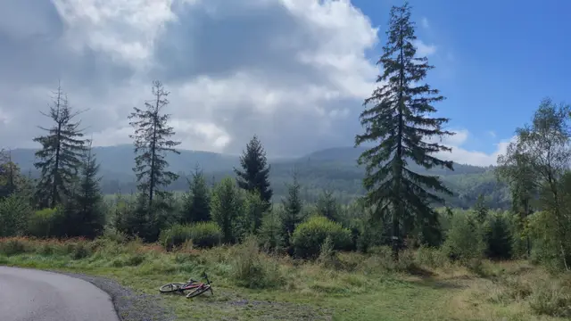 Red Bike Under Clouded Ridges